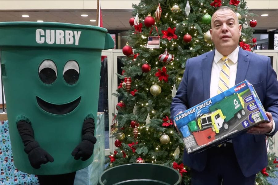 Town supervisor with the town's recycling mascot Curby.